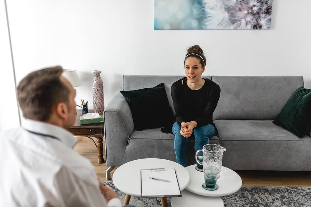 A client sits with a counsellor or psychotherapist